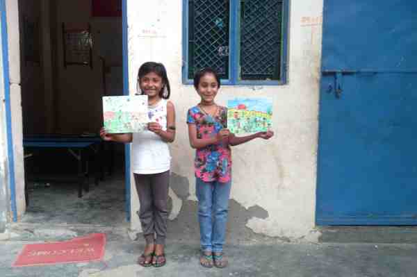 Imrana (8) and Vandana (8) showing their drawings outside RMN Foundation School in New Delhi