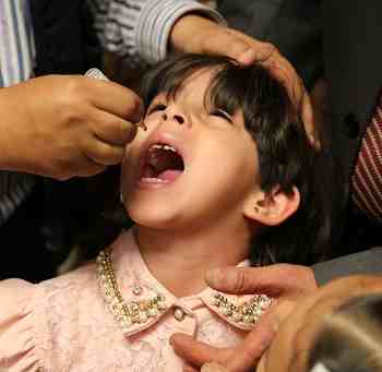 A girl is administered a dose of oral poliovirus vaccine in Sana’a, Yemen