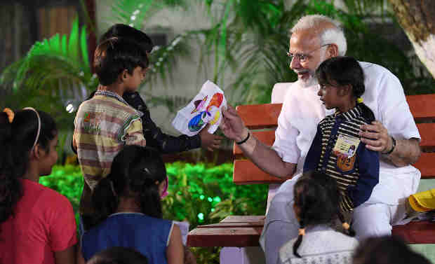 Narendra Modi interacting with the children from poor and underprivileged sections, in Varanasi, Uttar Pradesh on September 17, 2018