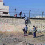 Students of a government school in Delhi cross high walls and barbed wires to abscond from the school. School education is bad and teachers have no control on students. Photo: Rakesh Raman / RMN News Service